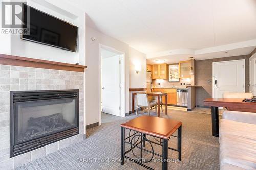 410 - 285 Steamship Bay Road, Gravenhurst, ON - Indoor Photo Showing Living Room With Fireplace