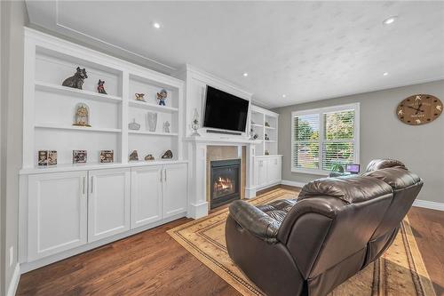 custom built in shelves, with tv and fireplace. - 58 Graystone Drive, Hamilton, ON - Indoor Photo Showing Other Room With Fireplace