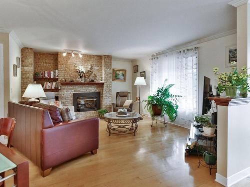 Salon - 32 Rue Roy, Saint-Roch-De-L'Achigan, QC - Indoor Photo Showing Living Room With Fireplace