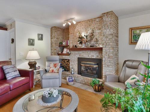 Salon - 32 Rue Roy, Saint-Roch-De-L'Achigan, QC - Indoor Photo Showing Living Room With Fireplace