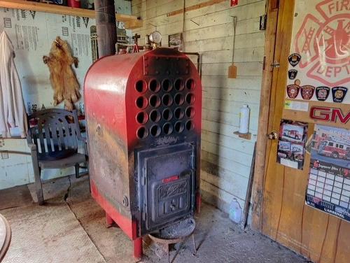 Garage - 107 Boul. Gérard-D.-Levesque, New Carlisle, QC - Indoor Photo Showing Other Room With Fireplace