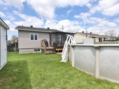 Backyard - 35 Rue Champagne, Saint-Constant, QC - Outdoor With Above Ground Pool