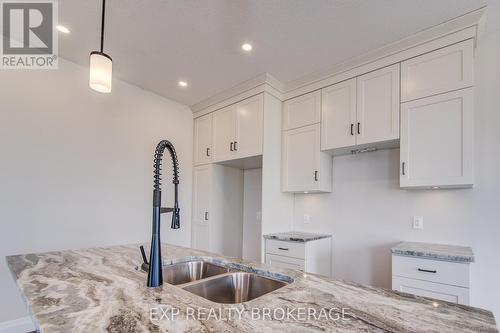 102 Thackeray Way, Minto, ON - Indoor Photo Showing Kitchen With Double Sink