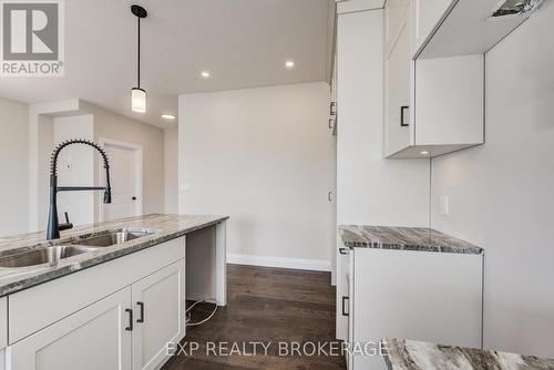 102 Thackeray Way, Minto, ON - Indoor Photo Showing Kitchen With Double Sink