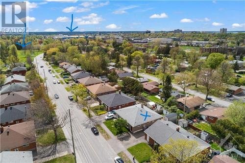 Drone viewing heading towards Ikea from the house.  The first arrow is the park and the second is IKEA. - 2403 Iris Street, Ottawa, ON - Outdoor With View