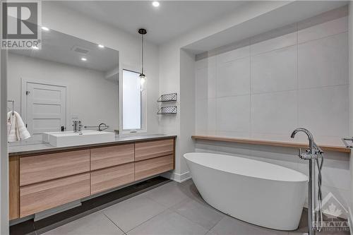 Primary ensuite includes a stand alone soaker tub. - 163 Irving Avenue, Ottawa, ON - Indoor Photo Showing Bathroom