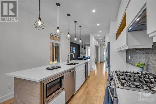 There is ample lighting; pot lights and accent lighting throughout the main level. - 163 Irving Avenue, Ottawa, ON - Indoor Photo Showing Kitchen With Double Sink With Upgraded Kitchen