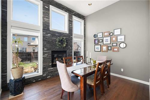 99 Blue Sun Drive, Winnipeg, MB - Indoor Photo Showing Dining Room With Fireplace