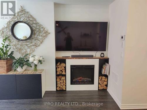 12 - 100 Long Branch Avenue, Toronto, ON - Indoor With Fireplace