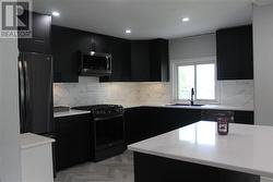 Newer kitchen with appliances and granite coutertops. - 