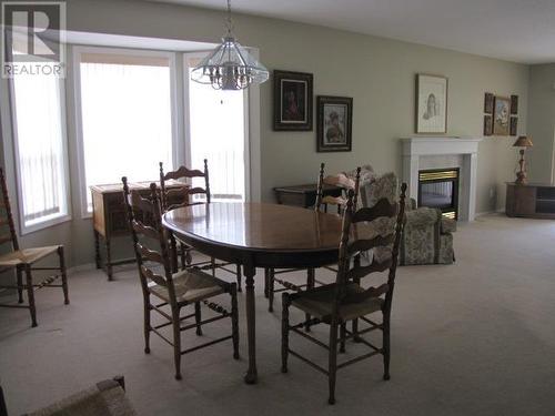 20 500 Wotzke Drive, Williams Lake, BC - Indoor Photo Showing Dining Room With Fireplace