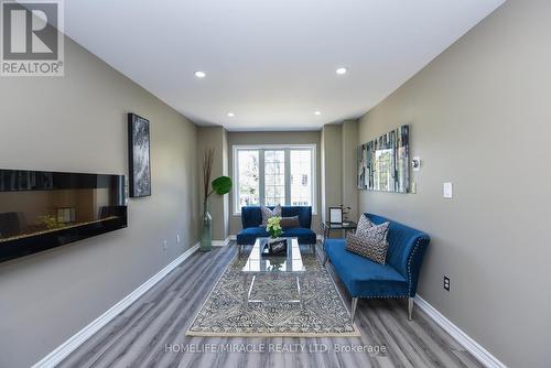 06 - 80 Acorn Place, Mississauga (Hurontario), ON - Indoor Photo Showing Living Room With Fireplace