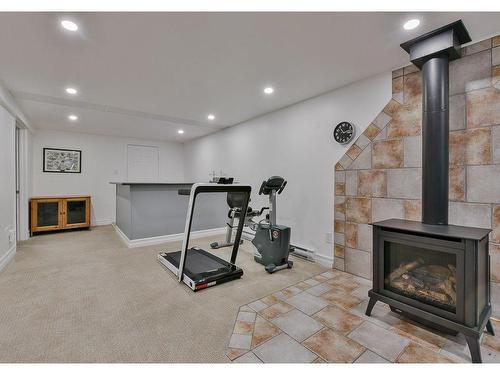 Exercise room - 57 Rue Des Pinsons, Saint-Basile-Le-Grand, QC - Indoor With Fireplace