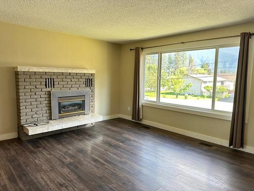 1791 78Th Avenue, Grand Forks, BC - Indoor Photo Showing Living Room With Fireplace