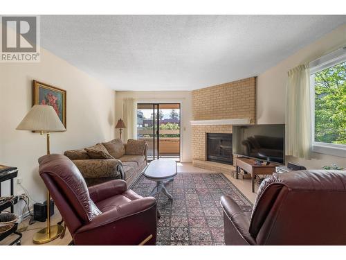 1035 Bernard Avenue Unit# 201, Kelowna, BC - Indoor Photo Showing Living Room With Fireplace