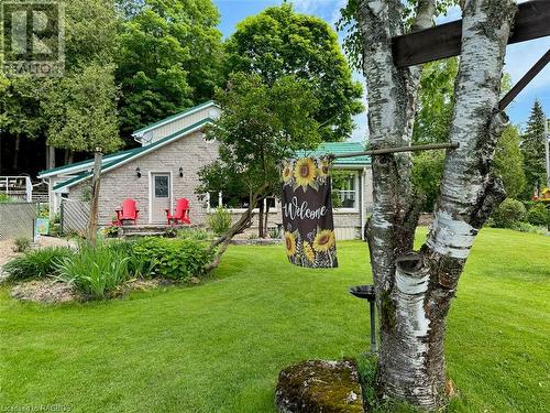 Walking from the driveway to the house on a natural stone path through the manicured property. - 47 Water Street, Northern Bruce Peninsula, ON - Outdoor