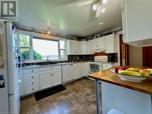 With large window offering a stunning Georgian Bay water-view. - 47 Water Street, Northern Bruce Peninsula, ON - Indoor Photo Showing Kitchen