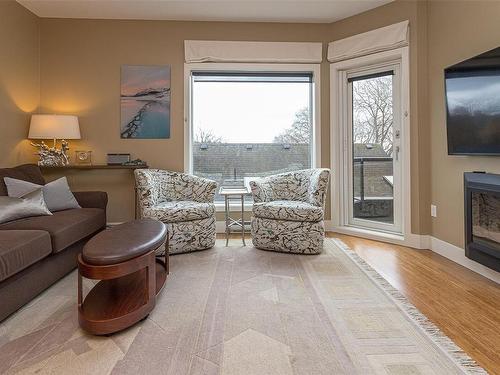 205-2589 Penrhyn St, Saanich, BC - Indoor Photo Showing Living Room With Fireplace