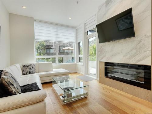 102-1018 Pentrelew Pl, Victoria, BC - Indoor Photo Showing Living Room With Fireplace