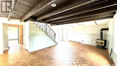 209 1St Street E, Dinsmore, SK - Indoor Photo Showing Other Room With Fireplace