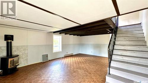 209 1St Street E, Dinsmore, SK - Indoor Photo Showing Other Room With Fireplace