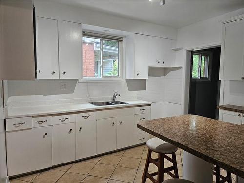 KITCHEN CABINET HAVE BEEN REMOVED - 212 Balmoral Avenue S, Hamilton, ON - Indoor Photo Showing Kitchen With Double Sink