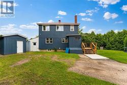 Storage shed (blue) and breezeway with covered wood storage (white) - 