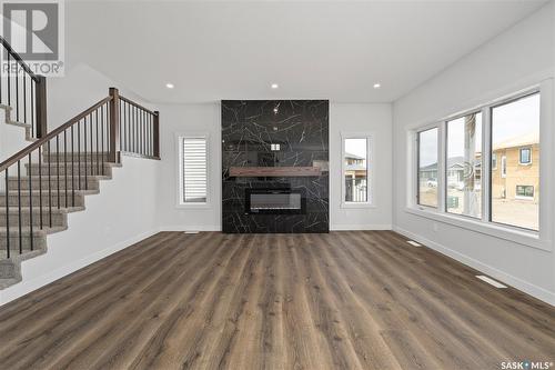 115 Woolf Bend, Saskatoon, SK - Indoor Photo Showing Living Room With Fireplace