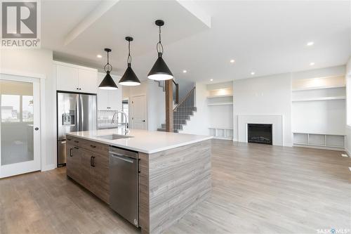 115 Woolf Bend, Saskatoon, SK - Indoor Photo Showing Kitchen With Fireplace With Upgraded Kitchen