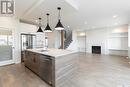 115 Woolf Bend, Saskatoon, SK  - Indoor Photo Showing Kitchen With Fireplace With Upgraded Kitchen 