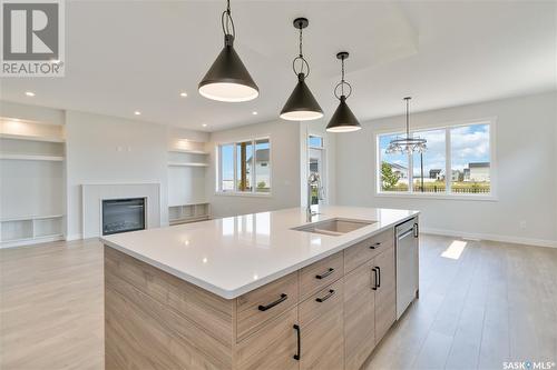 115 Woolf Bend, Saskatoon, SK - Indoor Photo Showing Kitchen With Fireplace