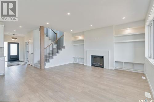 115 Woolf Bend, Saskatoon, SK - Indoor Photo Showing Other Room With Fireplace