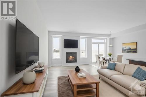 This home has not been built yet. Images provided are to showcase builder finishes. - 1922 Hawker Private, Ottawa, ON - Indoor Photo Showing Living Room With Fireplace