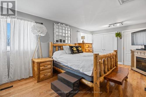 799 County Rd 24 Road, Kawartha Lakes, ON - Indoor Photo Showing Bedroom With Fireplace