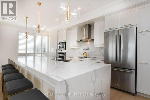 14X4 ft island with waterfall countertop - 1103 - 260 Villagewalk Boulevard, London, ON - Indoor Photo Showing Kitchen With Upgraded Kitchen