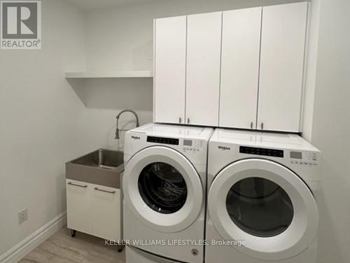 Updated custom cabinetry in the laundry room. - 1103 - 260 Villagewalk Boulevard, London, ON - Indoor Photo Showing Laundry Room