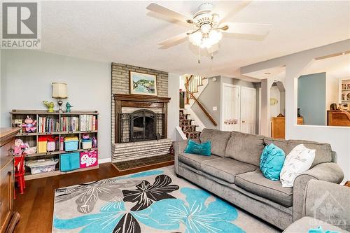 Cozy fireplace in this lower level walkout family room - 211 Park Avenue, Carleton Place, ON - Indoor Photo Showing Living Room With Fireplace