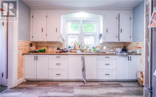 Kitchen is bright with plenty of cupboard and countertop space - 107 Cherry Street, Kitchener, ON - Indoor Photo Showing Kitchen