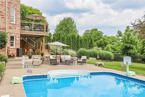 Or from the two tier decks.  It also includes... - 39 Sumner Crescent, Grimsby, ON - Outdoor With In Ground Pool With Backyard