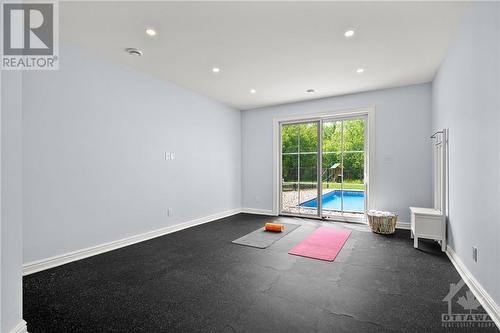 Gym with access to backyard - 153 Barrdon Road, Ottawa, ON - Indoor Photo Showing Other Room With In Ground Pool