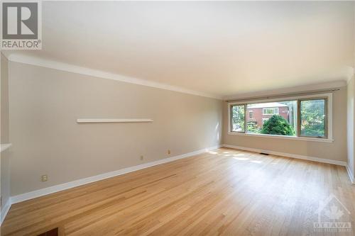 Main Floor Living/Dining Room with Hardwood Floors and Wood Burning Fireplace - 564 Highcroft Avenue, Ottawa, ON - Indoor With Fireplace