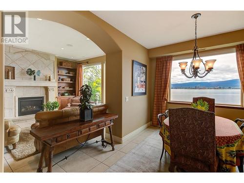 683 Westside Road S, West Kelowna, BC - Indoor Photo Showing Dining Room With Fireplace