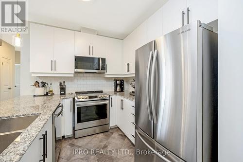 310 - 383 Main Street E, Milton, ON - Indoor Photo Showing Kitchen With Stainless Steel Kitchen With Double Sink With Upgraded Kitchen