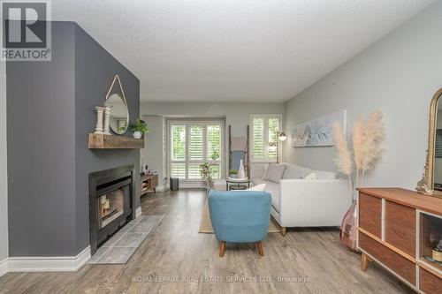 406 - 895 Maple Avenue, Burlington, ON - Indoor Photo Showing Living Room With Fireplace
