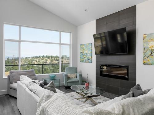 1140 Goldfinch Place, Kelowna, BC - Indoor Photo Showing Living Room With Fireplace