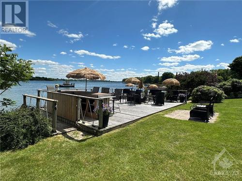 Deck overlooking the sandy, gradual beach - 9 Shoreline Road, Johnstown, ON - Outdoor With Body Of Water With View