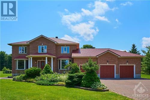 Full brick exterior & expanded driveway & high-quality metal roof - 42 Marchbrook Circle, Kanata, ON - Outdoor With Facade