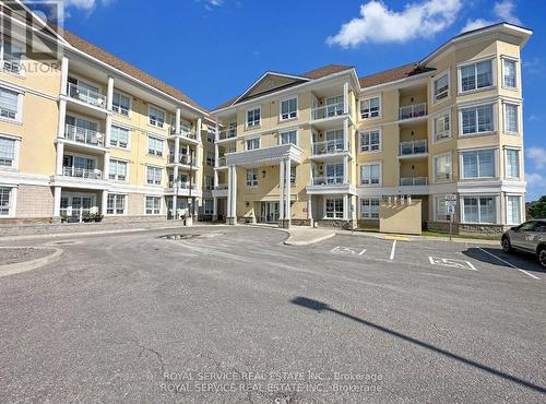 303 - 21 Brookhouse Drive, Clarington, ON - Outdoor With Balcony With Facade