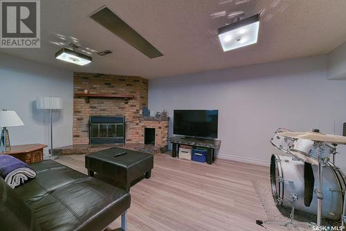 34 Forman Bay, Regina, SK - Indoor Photo Showing Living Room With Fireplace