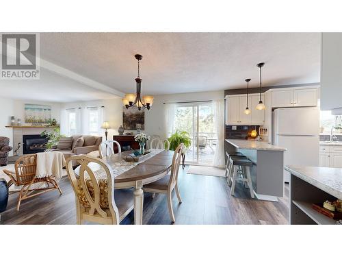 5151 Watson Lake Road, 100 Mile House, BC - Indoor Photo Showing Dining Room With Fireplace